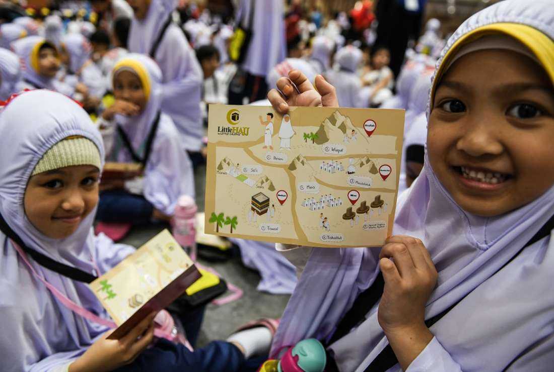 A Hijab-clad Muslim girl shows the order of religious rituals in a booklet after performing an educational simulation of the Hajj pilgrimage in Kuala Lumpur in this July 4, 2019 photo. Malaysia’s leading interfaith council has called the implementation of a module appreciating the teachings of Hadith in national schools by the Education Ministry as 'unconstitutional.'