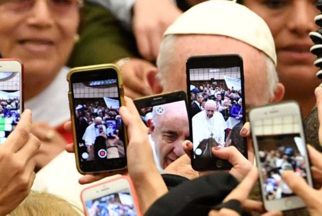 People taking photos and videos of Pope Francis at the weekly General Audience