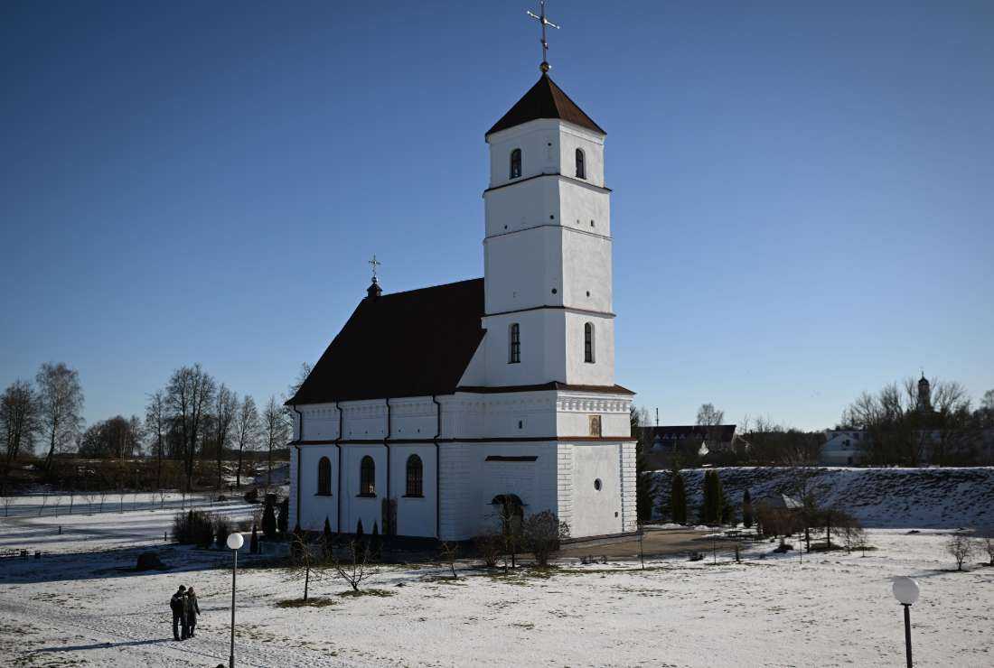 People walk past an Orthodox church in the Belarusian town of Zaslavl, outside the capital Minsk, on Feb. 14