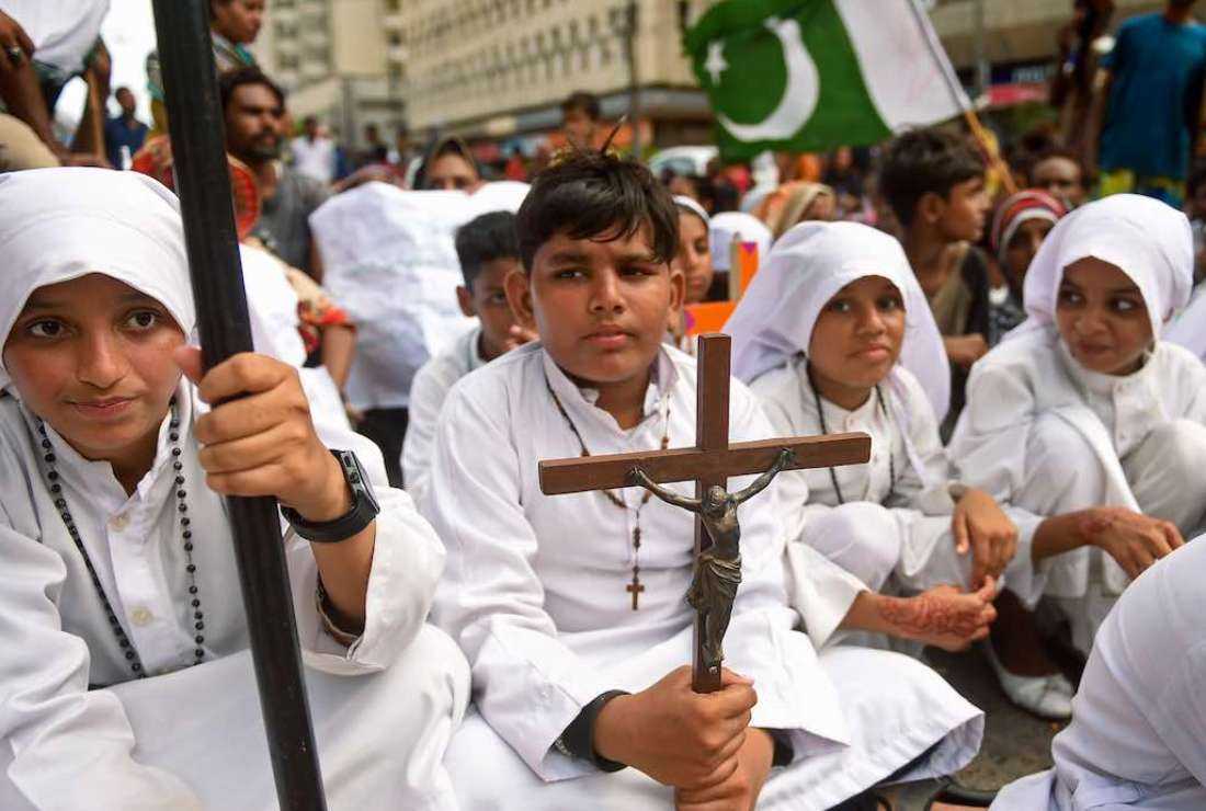 Children dressed as priests and nuns sit on a public road holding crosses during a protest in Karachi on Aug 22, 2023, against an attack on Christians in Pakistan, after several Christian homes and churches were vandalized in an hours-long riot in Jaranwala in Punjab province on Aug 16, following allegations that a Quran had been desecrated spread through the city