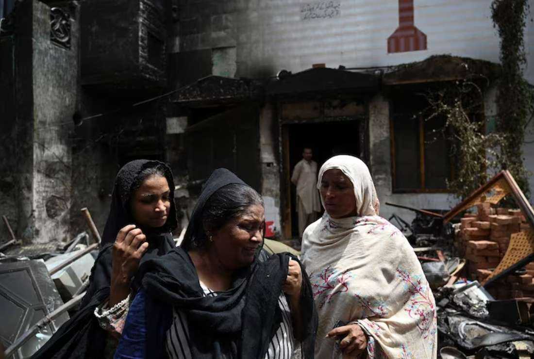 Pakistani Christian Perveen Bibi weeps outside the torched St. John's Church in Jaranwala on the outskirts of Faisalabad on Thursday, a day after an attack by Muslim men following the spread of allegations that Christians had desecrated the Quran