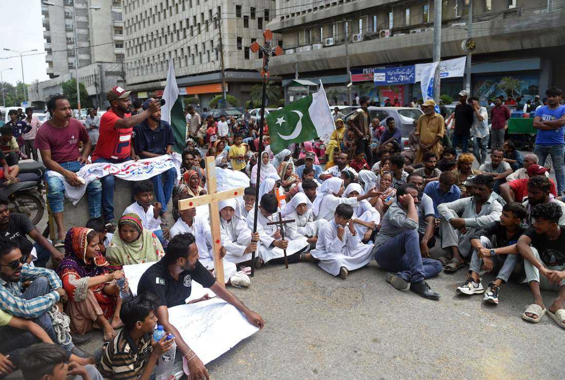 Christians hold the holy cross and placards during a protest in Karachi on Aug. 22 to condemn the attack on churches in Pakistan. More than 80 Christian homes and 19 churches were vandalized in an hours-long riot in Jaranwala in Punjab province on Aug. 16, after allegations that a Koran had been desecrated spread through the city
