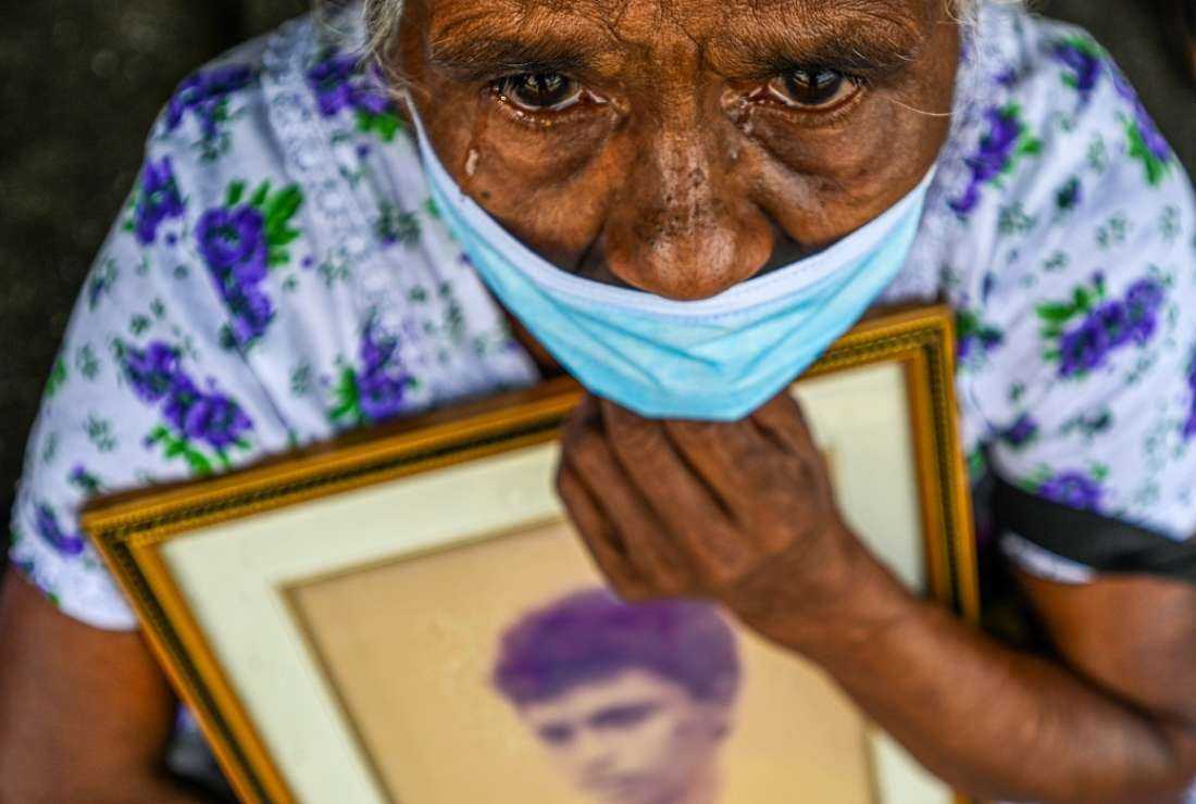 A woman holds an image of her family member who went missing during the height of the island’s Tamil separatist war that ended in May 2009, during a demonstration near the national parliament in Colombo on Dec 5, 2022