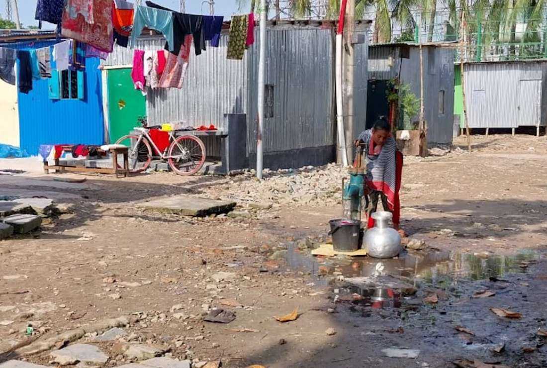 A woman draws water from the only hand pump available to 126 Telugu families -- mostly Christians and Hindus -- in their new settlement after they were evicted from their homes in the Outfall Colony in Dhaka’s Dholpur area in February