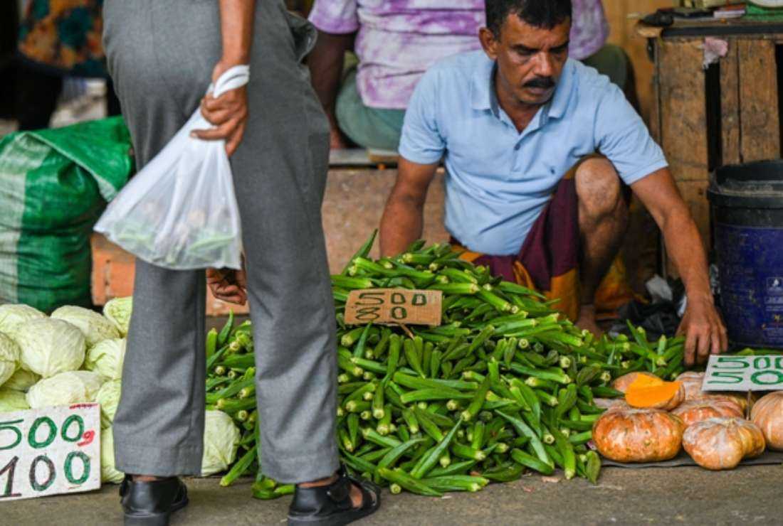 A vendor arranges vegetables at a market in Colombo on July 4. There is no price control for essential goods in the market and many people are on the verge of starvation in bankrupt Sri Lanka, say Catholic bishops