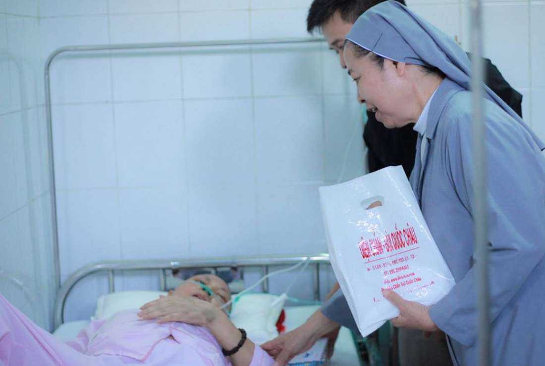 A Catholic nun visits a sick person in his house in Thua Thien Hue province on April 26, 2023