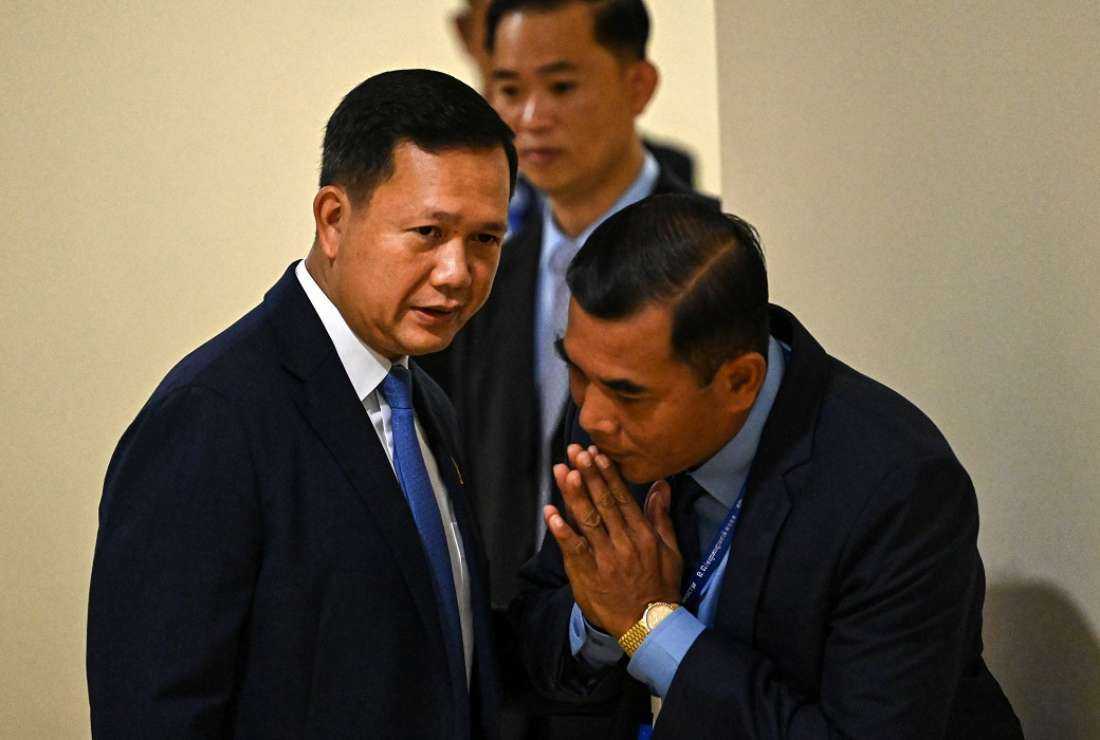Cambodia's Prime Minister-designate Hun Manet (L) speaks with a bodyguard as he attends a parliamentary meeting at the National Assembly building in Phnom Penh on Aug 22, 2023. Cambodia’s parliament on Aug 22 elected long-time ruler Hun Sen’s eldest son as the country’s new prime minister, sealing a dynastic handover of power after last month’s one-sided election