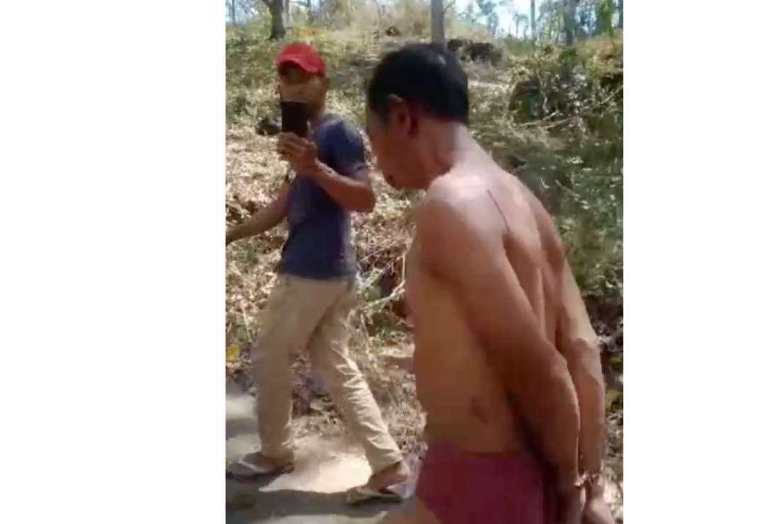 A video screen shot shows Thomas Barus being paraded in Indonesia's West Manggarai Regency on Sept. 2 after he reportedly raped several schoolgirls