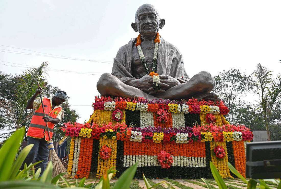 A sanitation worker sweeps in front of a statue of Mahatma Gandhi on his death anniversary in Hyderabad on Jan 30.