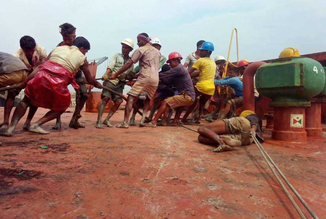 Workers dismantling a ship without adequate protective equipment in Chattogram, Bangladesh. 