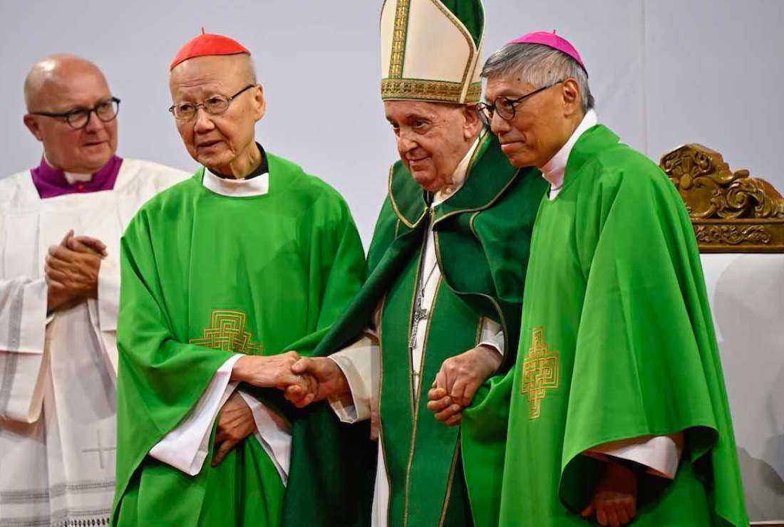 Pope Francis (C) with Hong Kong's Bishop Stephen Chow (R) and its retired Bishop Cardinal John Tong (L) after a Mass at the Steppe Arena in Ulaanbaatar on Sept 3, 2023. Pope Francis addressed Catholics in China in impromptu comments following a Mass, telling them to be 'good Christians and good citizens