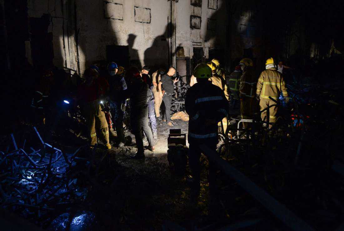 Civil defense members inspect the scene of a fire that broke out during a wedding at an event hall in Al-Hamdaniyah, Iraq on Sept. 27.