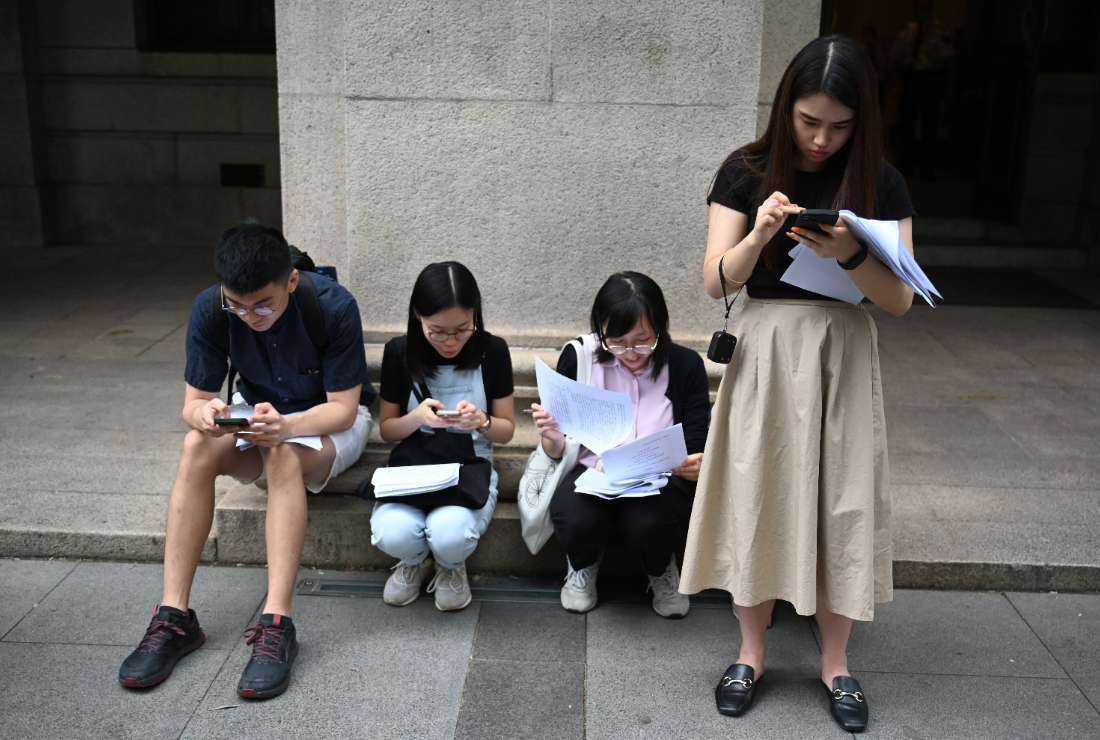 Journalists read the latest ruling on same-sex marriage decided by the Court of Final Appeal in Hong Kong on Sept. 5