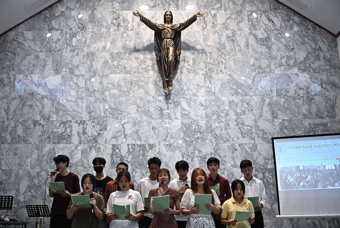 Members of the Vietnamese Hmong community living in Thailand, many of whom are asylum seekers, sing during Sunday service at a Christian church in Bangkok on Aug. 20