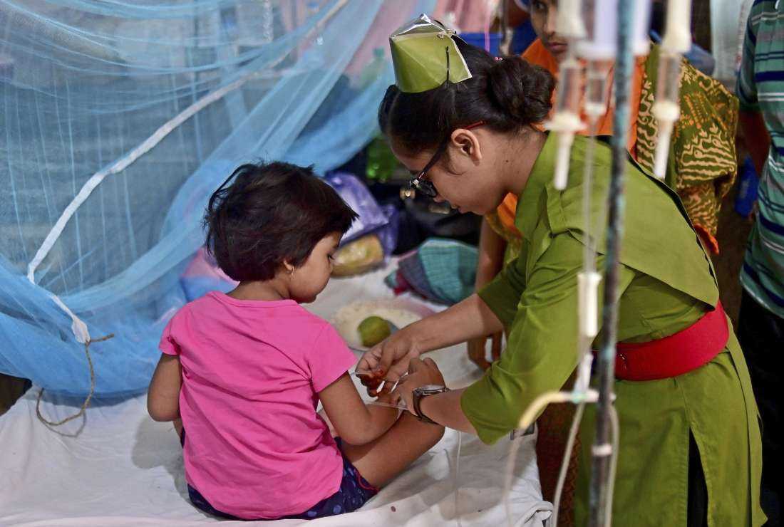 A nurse tends to a child suffering from dengue fever at a government hospital in Dhaka last year