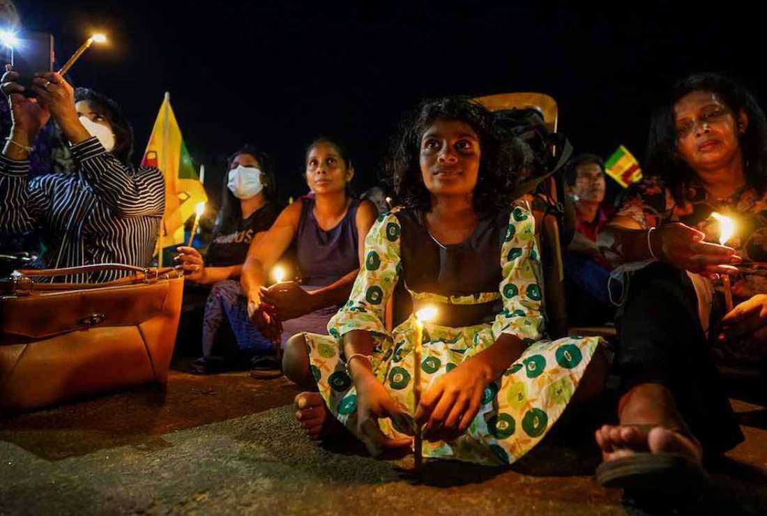 Demonstrators light candles during a silent protest to pay respect to the victims of the 2019 Easter Sunday suicide bombings at three churches and three deluxe hotels that killed almost three hundred people, on the day to mark the third anniversary of the attacks near the president's office in Colombo on April 21, 2022.