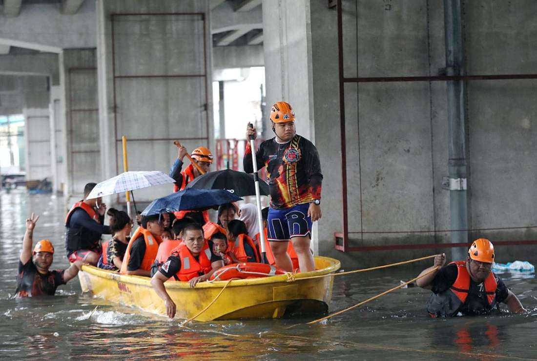 Rescuers evacuate flood-affected people in Quezon City of Philippine capital Manila