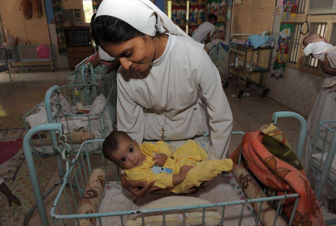 An orphaned Indian baby girl is placed in a cradle by a nun at The Matruchhaya Orphanage which is run by The Sisters of Charity of St. Anne Trust in Nadiad some 60kms. from Ahmedabad in this Oct 29, 2011 file photo