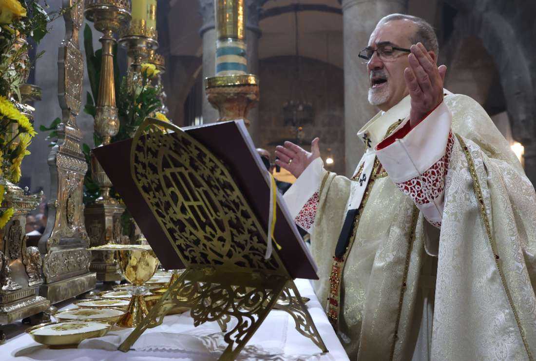 Latin Patriarch of Jerusalem Pierbattista Pizzaballa (center) leads a mass on Easter Sunday at the Church of the Holy Sepulchre in Jerusalem on April 9. 
