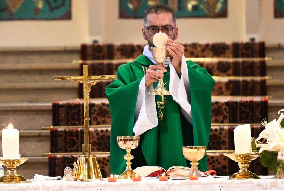 Father Fabrice Langefeld celebrates the Eucharist during a mass in memory of four of the eleven victims from the APEI Val de l'Orne association in Amneville at Saint-Joseph church of Amneville, eastern France, on Aug. 13..