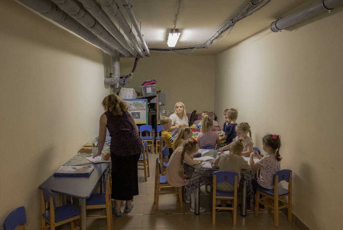 Children and their teachers wait in a kindergarten's basement used as a bomb shelter during an air strike alarm in Kryvyi Rih, southern Ukraine, on Sept. 14 amid the Russian invasion of Ukraine. 