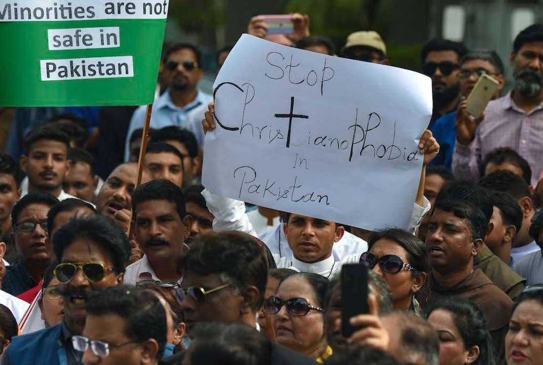 Civil society activists and members of the Christian community hold placards as they take part in a protest to condemn the attacks on churches in Pakistan, in Karachi on Aug. 18