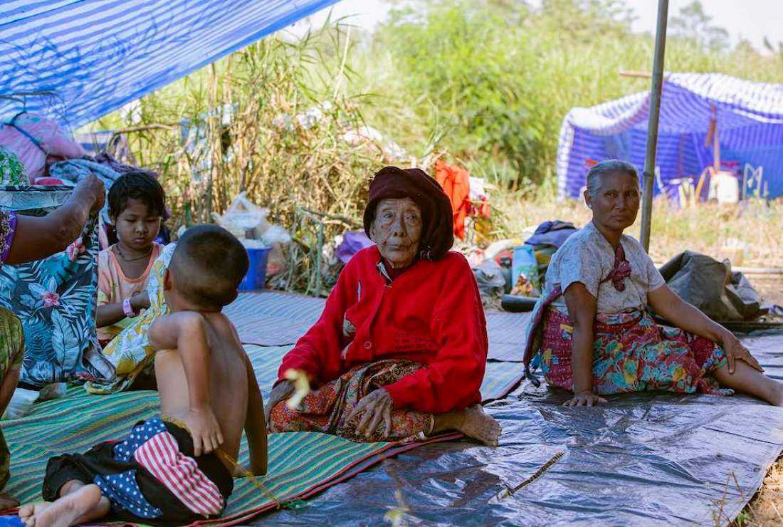 This photo taken on Jan. 15, 2022, shows Myanmar refugees, who fled a surge in violence as the military cracks down on rebel groups, resting after crossing a river on the border in Thailand's Mae Sot district.