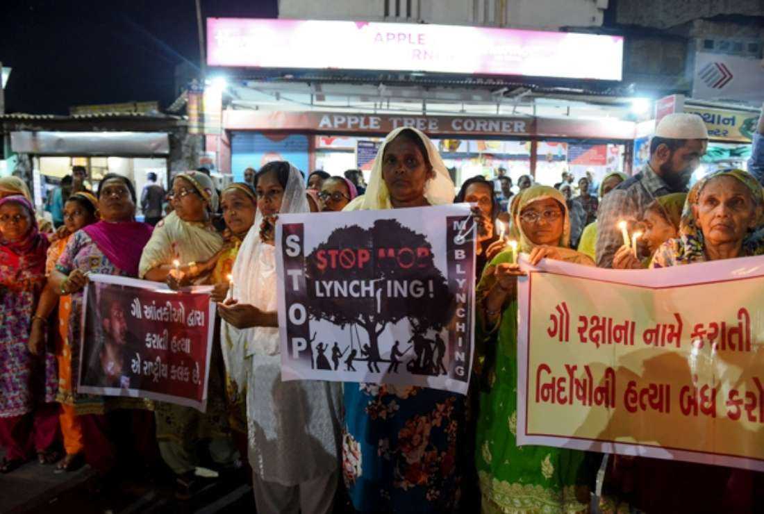Indian Muslims hold candles and posters as they protest against the mob lynching of Tabrez Ansari in the eastern Jharkhand state, in Ahmedabad city on June 27, 2019