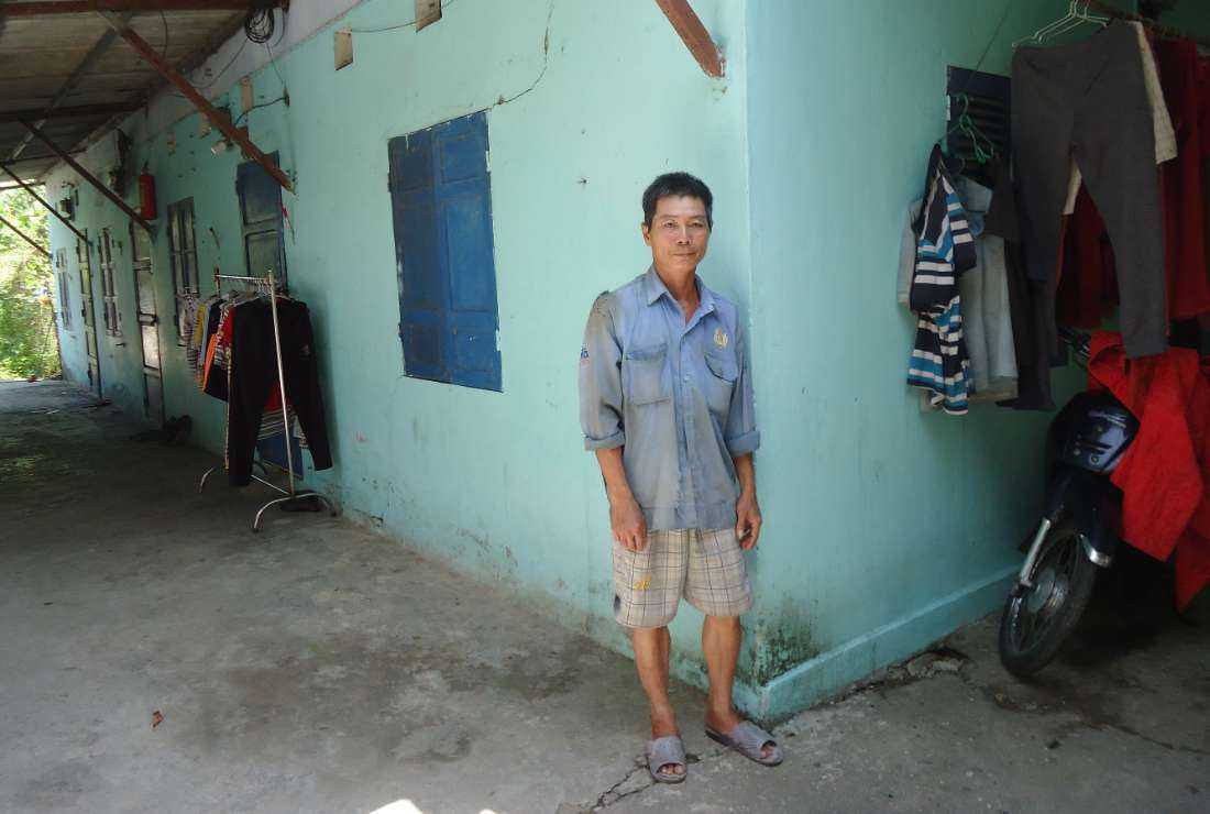 John Baptist Dang Thanh Cau stands before his rented house in Thua Thien Hue province