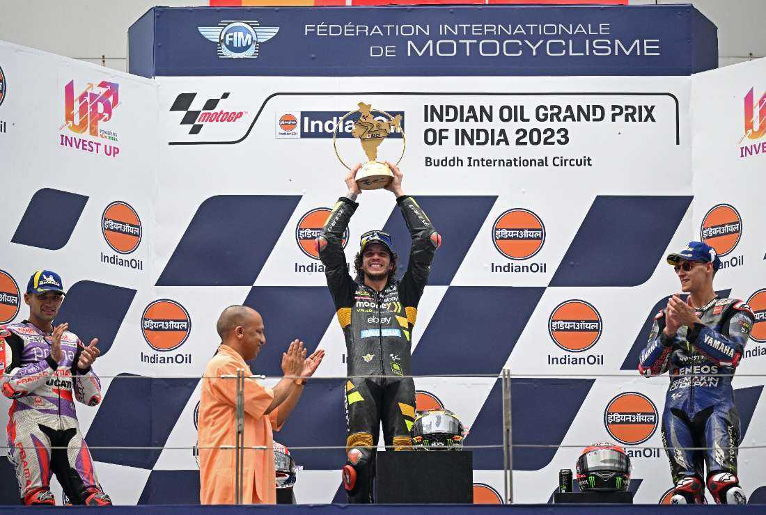 Yogi Adityanath, chief minister of Uttar Pradesh, with Italian rider Marco Bezzecchi  at the Indian MotoGP Grand Prix, held in  Greater Noida on the outskirts of capital New Delhi, on Sept. 24. Under Adityanath, Uttar Pradesh enacted the draconian anti-conversion law.