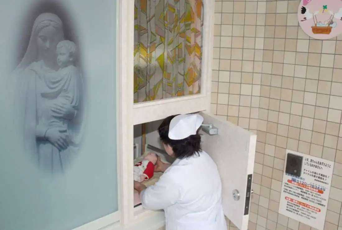 A nurse demonstrates Japan's first 'baby hatch,' where parents can drop off unwanted infants anonymously, during a press preview at the Jikei Hospital in Kumamoto, on Japan's southern island of Kyushu, on May 1, 2007