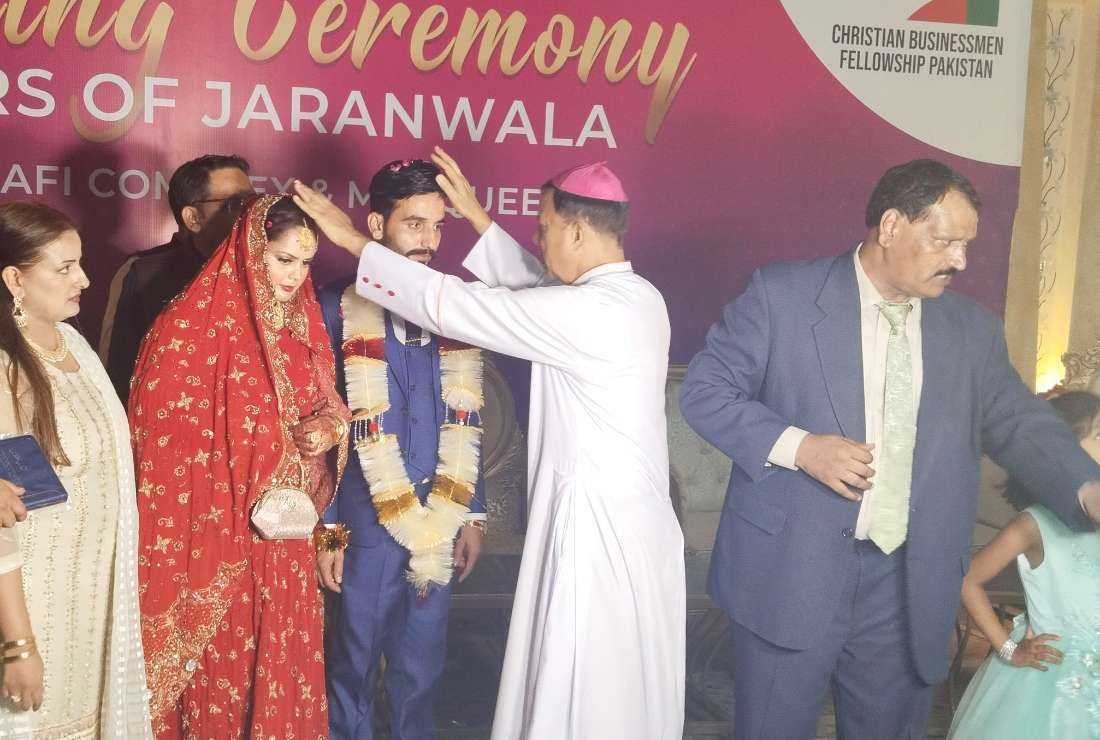 Archbishop Sebastian Shaw blesses a couple at a mass wedding ceremony on Oct. 13 in Jaranwala in Pakistan’s Punjab province, nearly two months after an anti-Christian riot destroyed 91 Christian houses.