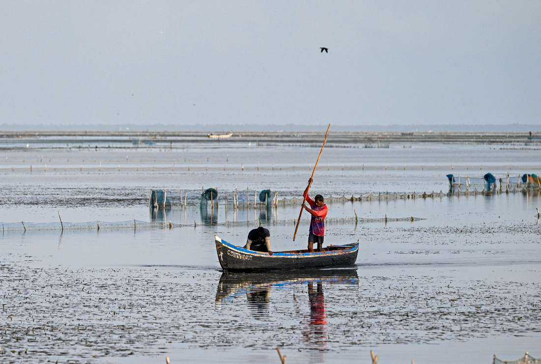 Fishermen ride their boat along the shoreline in Jaffna on Aug. 10.  During the three decades old civil war, connectivity to Jaffna, a Tamil stronghold, was damaged beyond repair.