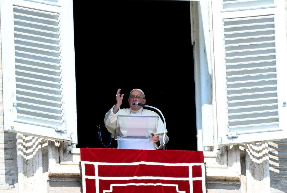 Pope Francis delivers his blessing to the pilgrims during the Sunday Angelus prayer in St.Peter's Square at the Vatican on Oct