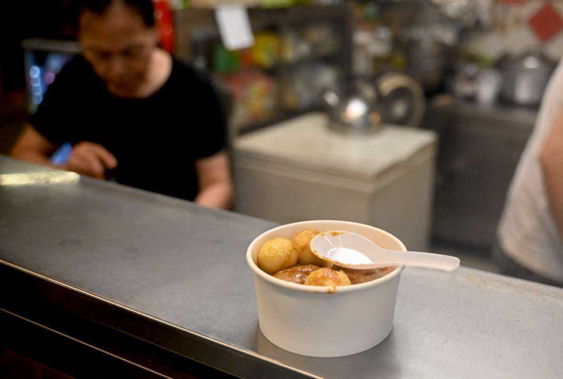 A bowl of Chinese fishballs are served with a plastic spoon at a takeaway counter in Hong Kong on Oct. 18