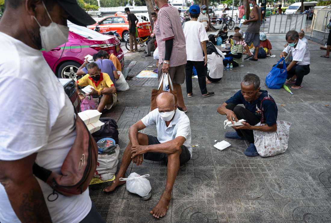 This photo taken on Sept. 22 shows senior citizens queuing up for daily food donations from Bangkok Community Help Foundation, near the Grand Palace in Bangkok. 