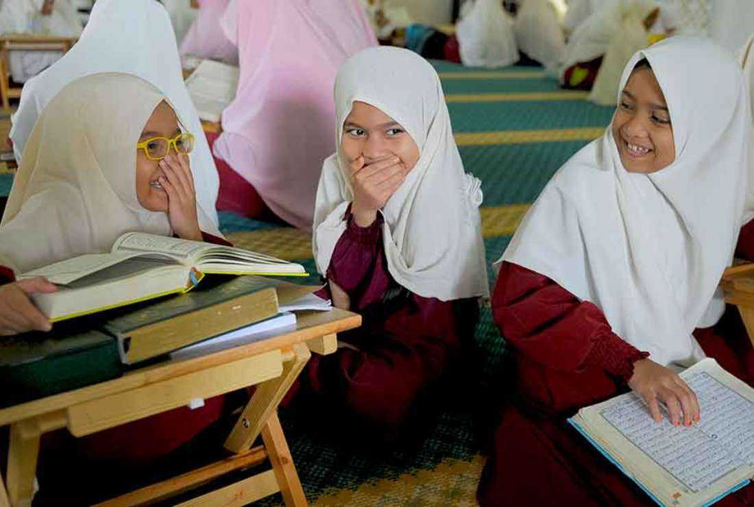 This file photo shows Malaysian students smiling at a girls-only Islamic school in Hulu Langat, on the outskirts of Kuala Lumpur.