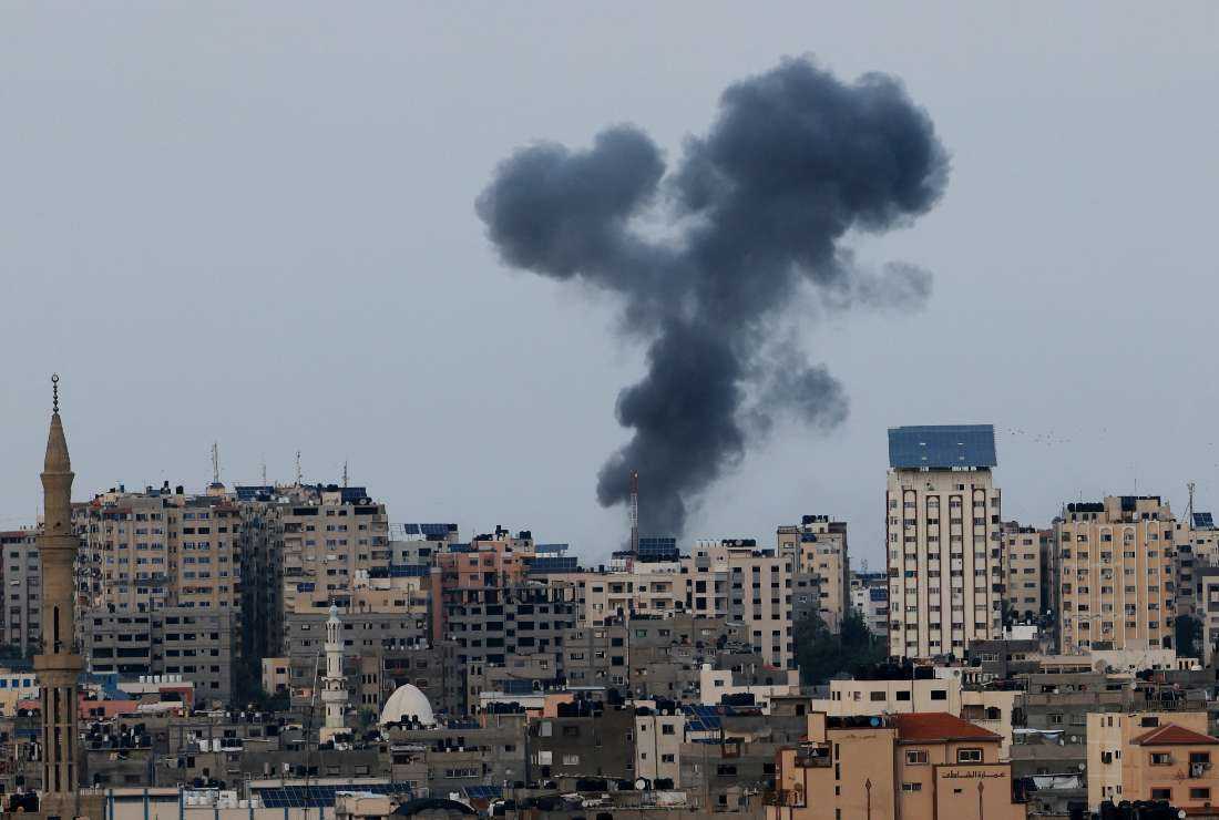 A plume of black smoke rises above Gaza City's skyline during an Israeli air strike on Oct. 8