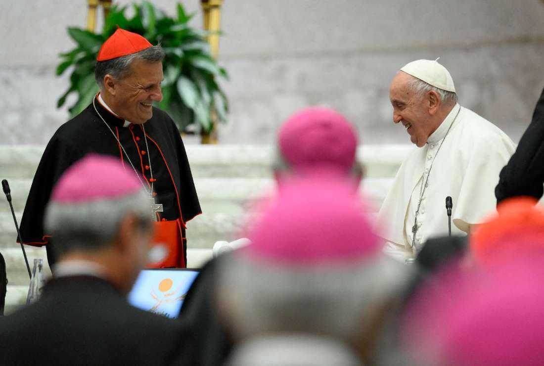 This photo taken and handout on Oct. 28 by The Vatican Media shows Pope Francis (right) and Cardinal Mario Grech (left) attending the last day of the 16th General Assembly of the Synod of bishops in The Vatican.
