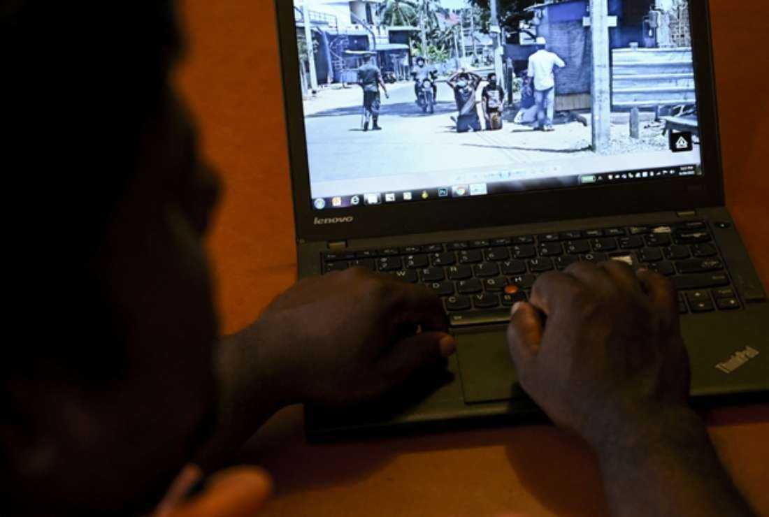 In this photo illustration taken on June 20, 2021, a user checks out a social media post on his laptop in Colombo after Sri Lanka's military launched an investigation after social media posts showed soldiers humiliating minority Muslims by forcing them to kneel on the streets during Covid-19 coronavirus lockdown.