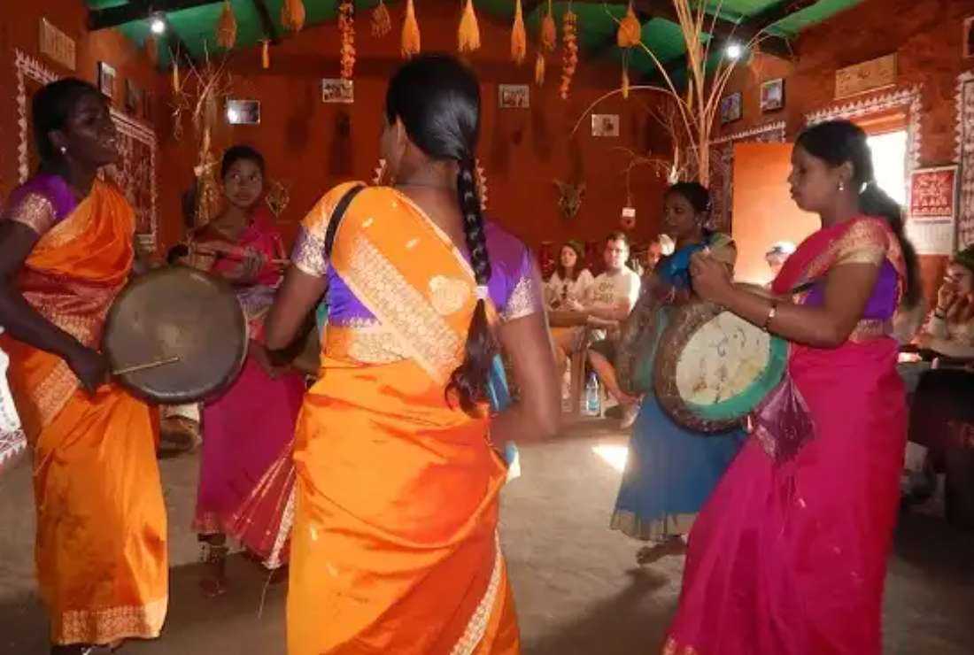 Tribal women performing their traditional dance in front of a group of foreign tourists at Jana Vikas Center in the eastern Odisha state, India.