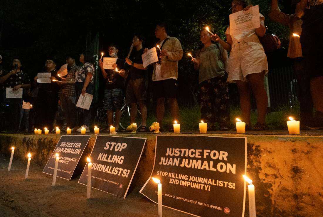 The College Editors' Guild of the Philippines and others hold a protest vigil outside the Commission on Human Rights to condemn the killing of Juan Jumalon in Manila on Nov. 5. 