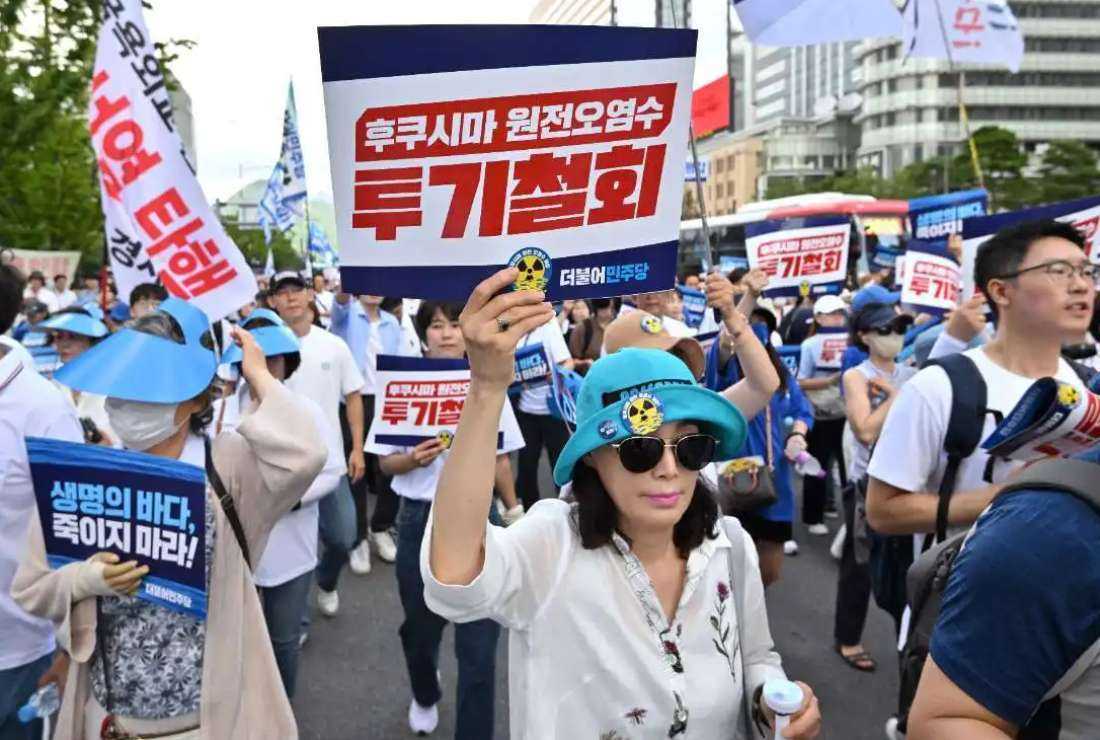 Protesters holding placards reading 'Stop dumping Fukushima nuclear-contaminated water into the ocean!' march during a rally against Japan's discharge of treated wastewater from the crippled Fukushima nuclear power plant, in Seoul on Aug. 25