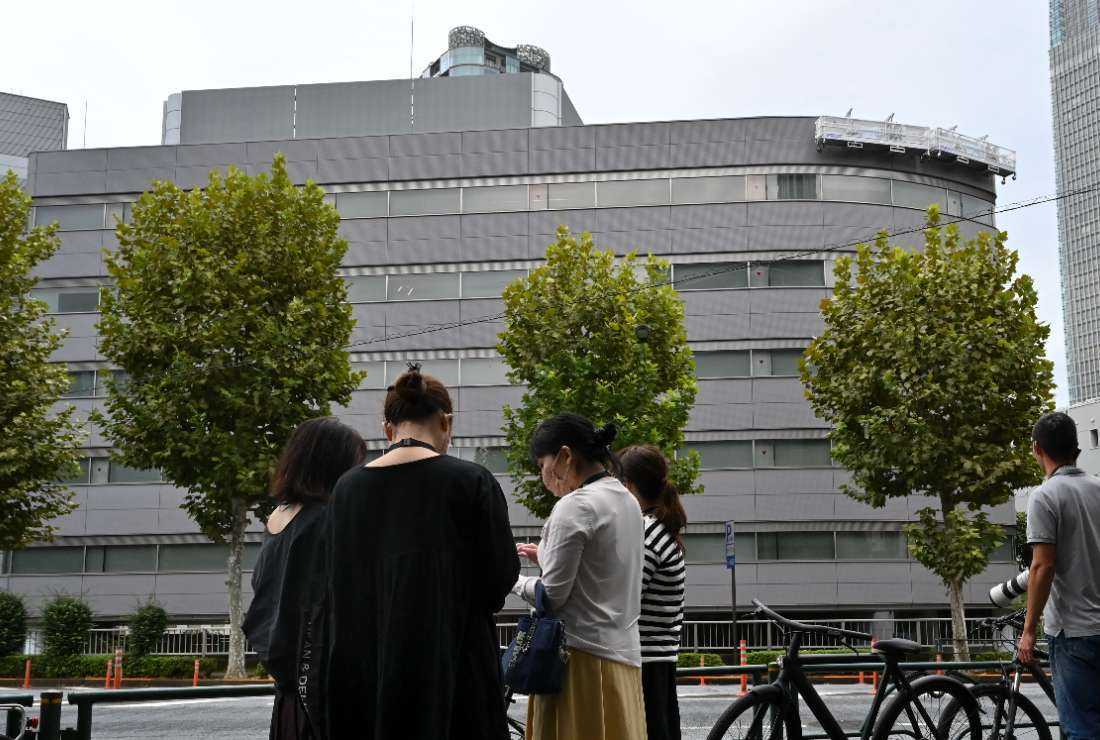 Onlookers gather outside the office building of scandal-hit Japanese talent agency Johnny & Associates in Tokyo on Oct. 5.