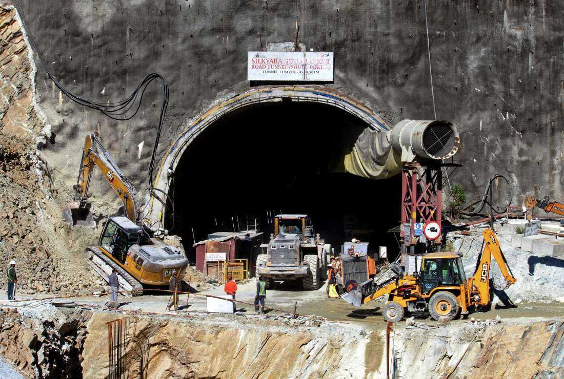 Rescue workers stand at an entrance of the under-construction road tunnel, days after it collapsed in the Uttarkashi district of India's Uttarakhand state on Nov. 18