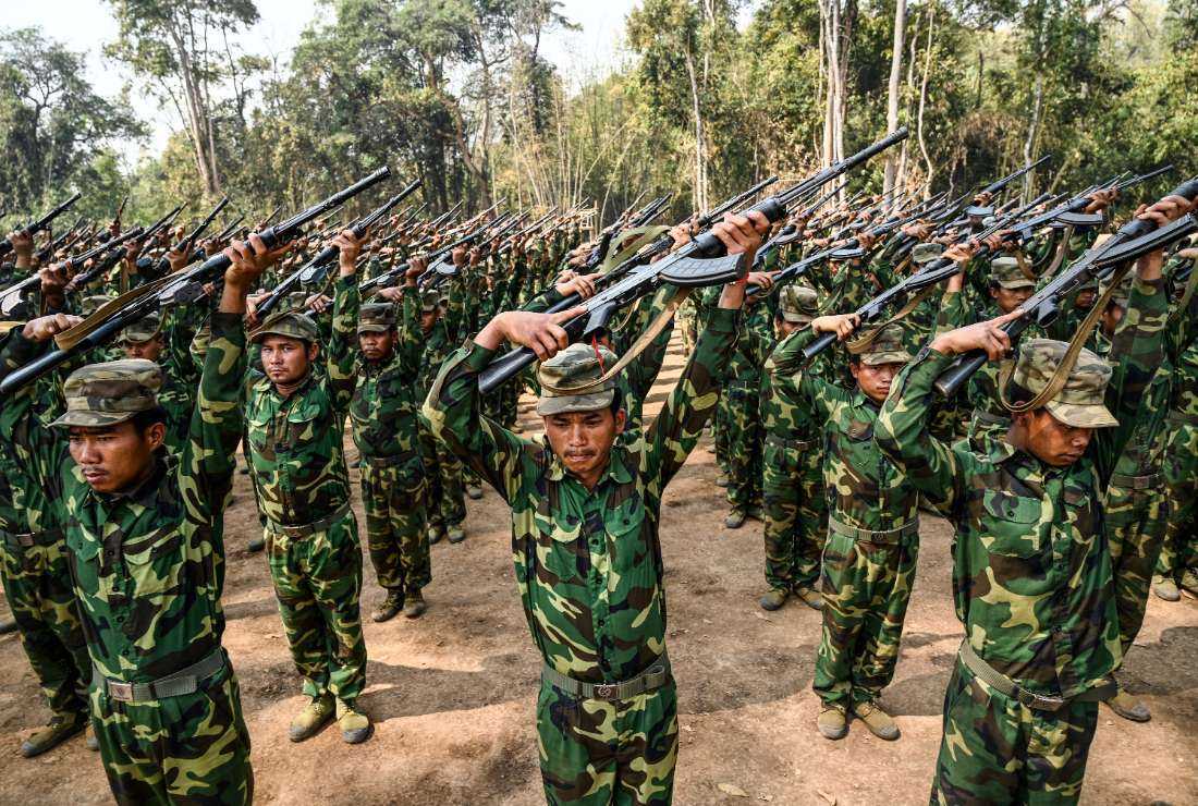 In this photo taken on March 8, members of the ethnic rebel group Ta'ang National Liberation Army (TNLA) take part in a training exercise at their base camp in the forest in Myanmar's northern Shan State.