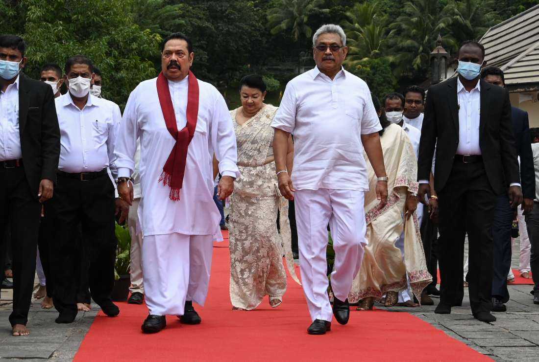 Sri Lanka's President Gotabaya Rajapakse (second right) and Prime Minister Mahinda Rajapakse (second left) leave after the new cabinet swearing-in ceremony at the Buddhist Temple of the Tooth in the ancient hill capital of Kandy, some 116 km from Colombo on Aug. 12, 2020. 