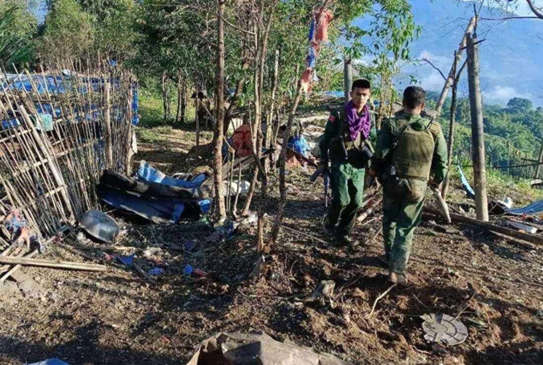 This handout photo taken and released on Oct. 28 by the Kokang Information Network shows members of the Myanmar National Democratic Alliance Army walking past a Myanmar military base after seizing it during clashes near Laukkaing township in Myanmar’s northern Shan state.