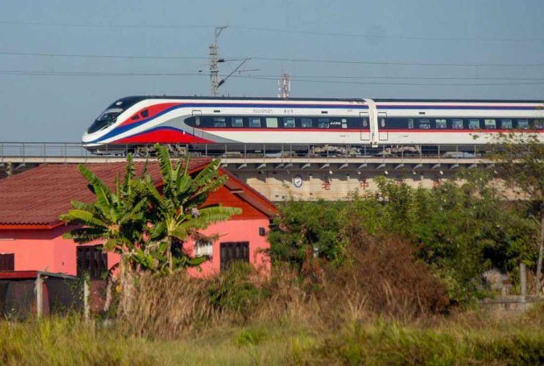 A train passes through villages and fields on Dec. 3, 2021, in Xaythani district, Vientiane, Laos. 