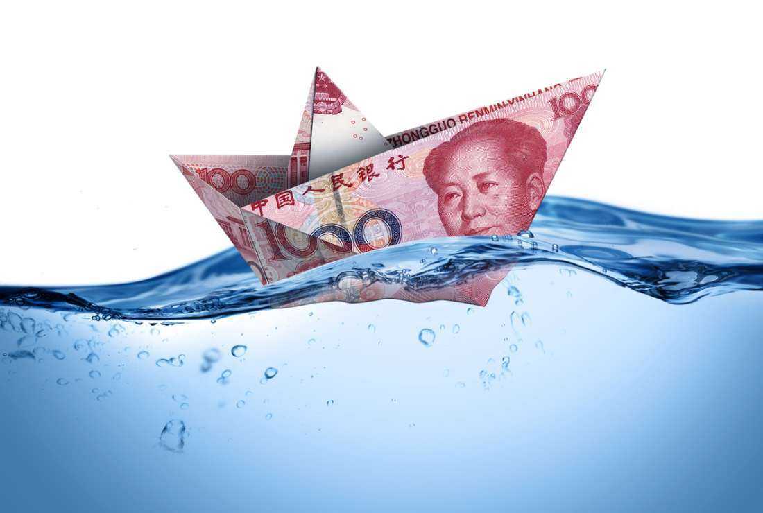 This graphical image shows a Chinese Yuan folded into a boat and placed in water.